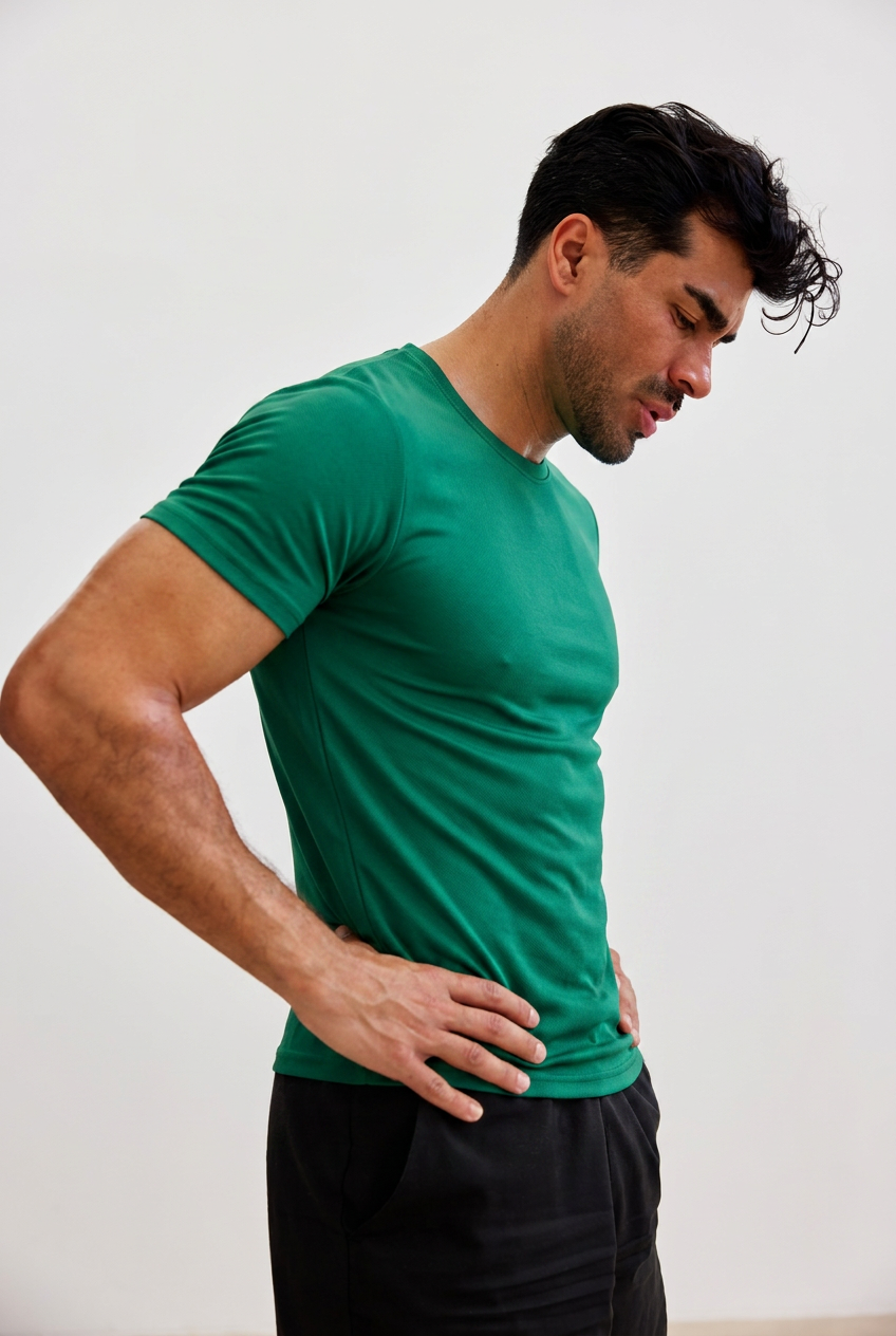Man in a fitted green performance tee and black joggers